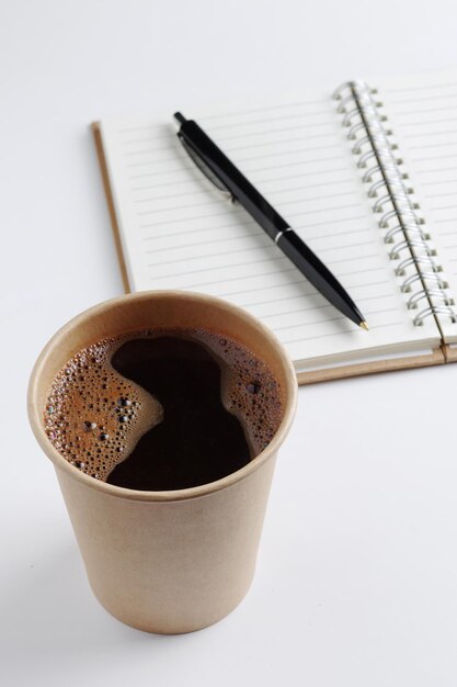 Glass of coffee notebook and pen