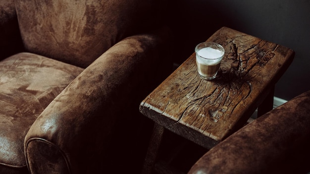 Glass of coffee on rustic wooden coffee table