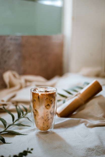 glass of coffee with milk on a white canvas