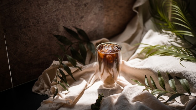 glass of coffee with milk on a white canvas