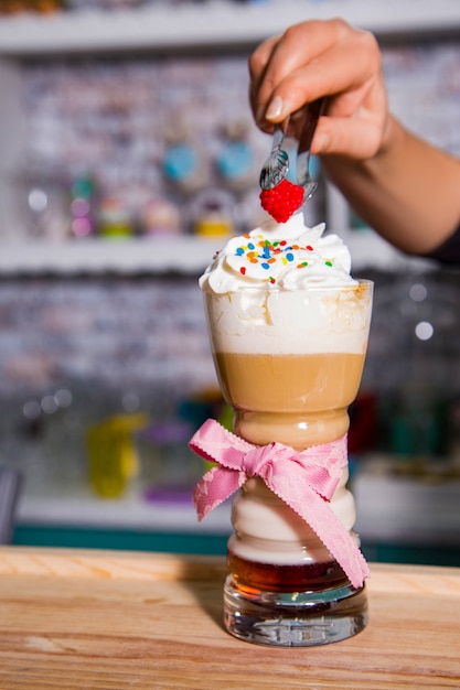 Glass Of Cold Coffee With Whipped Cream On Wood