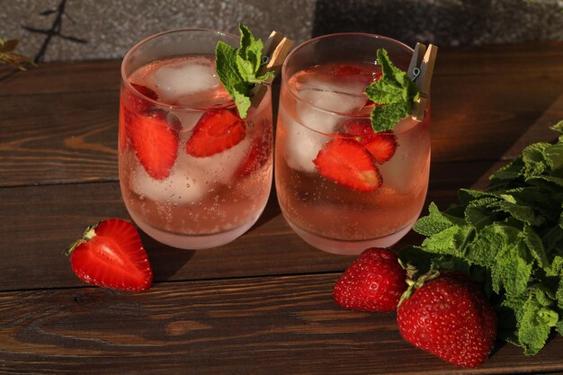 glass of cold drink with strawberry and mint