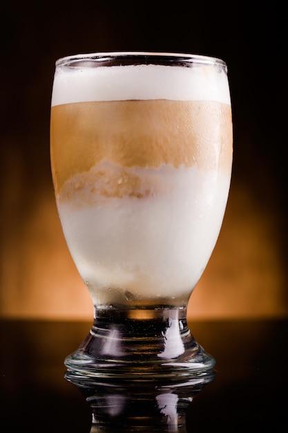 A glass of cold latte on a table