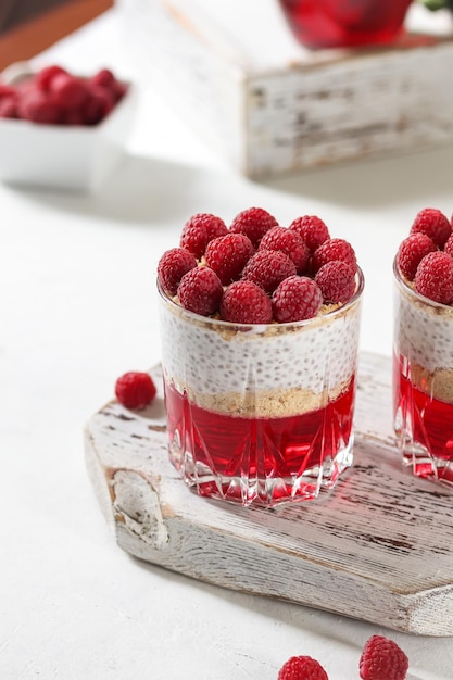 a glass container with raspberries in it