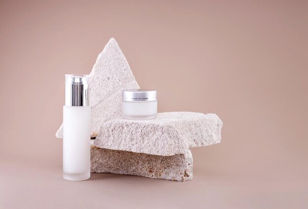 Glass containers for natural cosmetics on a podium made of concrete stones