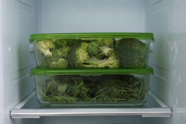 Glass containers with different fresh products in fridge Food storage