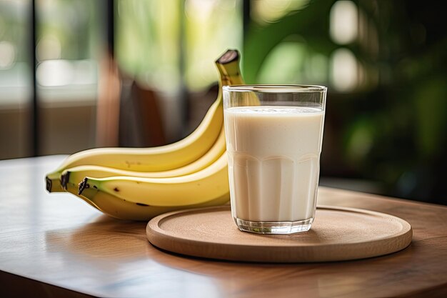 a glass containing a banana smoothie rests on a wooden tabletop