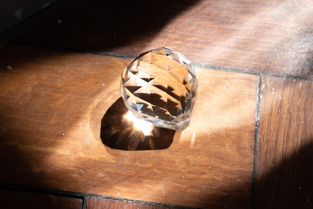 Photo glass crystal on the parquet floor in the sun