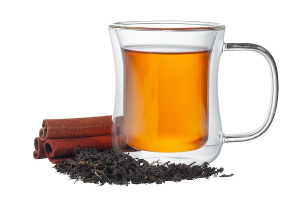 Glass cup of tea and cinnamon sticks isolated