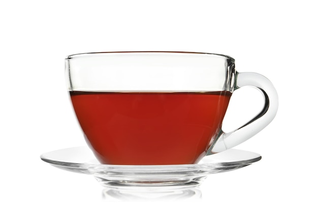 Glass cup of tea and saucer on white background