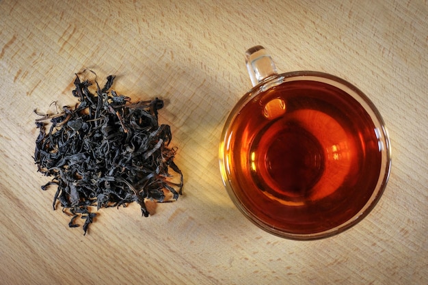 Glass cup of tea on a wooden table View from above