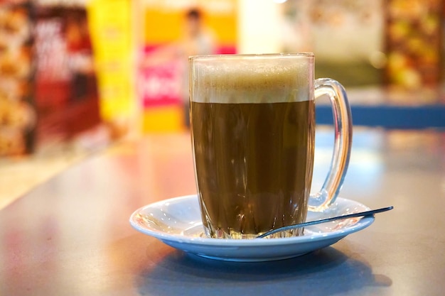 Glass cup with cocoa on a table in a cafe