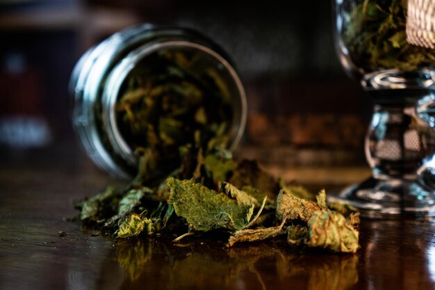 Glass cup with dry leaves for infusion