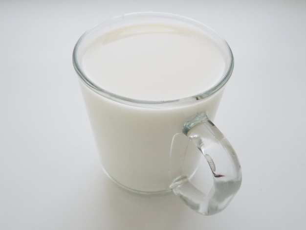 Glass cup with milk on a white background. Diet protein food