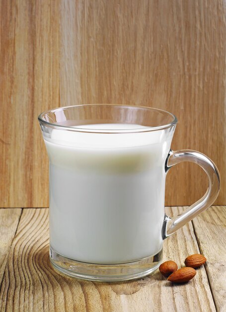 Glass cup with milk on a wooden table