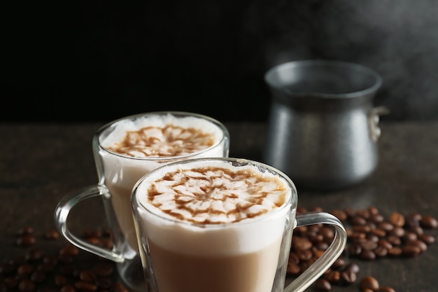 Glass cups with latte macchiato on table