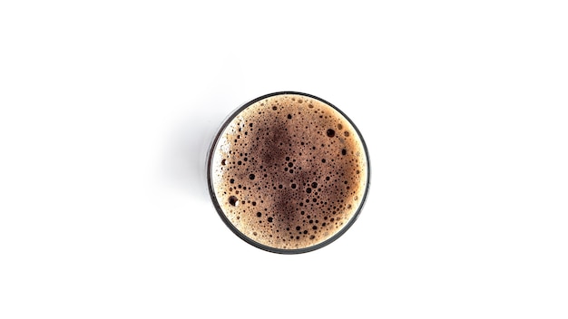 Glass of dark beer on white