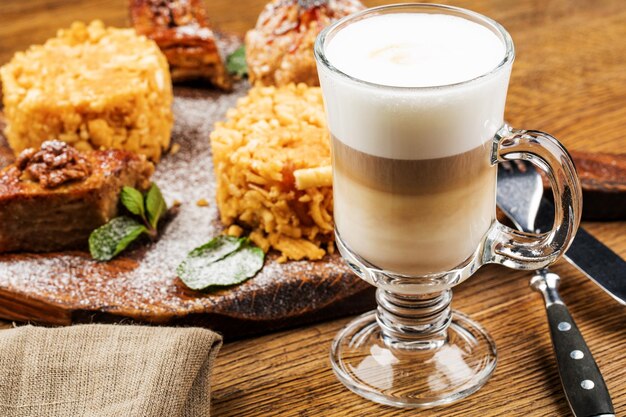 A glass of delicious latte on wooden table