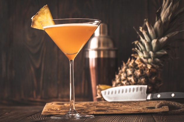 Glass of Downhill racer cocktail garnished with pineapple wedge