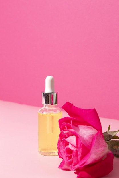 Glass dropper bottle with rose flower Hyaluronic acid oil serum with collagen and peptides skin care product Mockup packaging cosmetic design branding