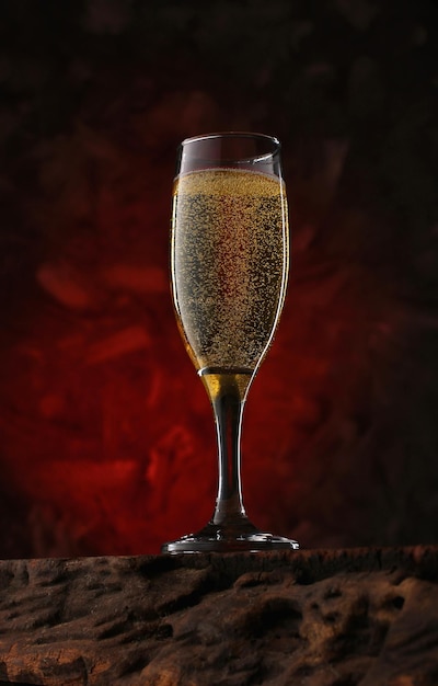 a glass of festive champagne on a textured wooden table