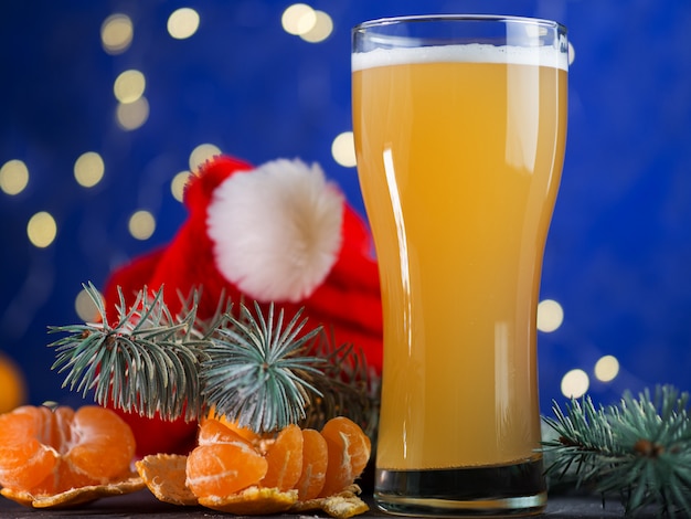 A glass of festive Christmas craft beer on a blue . Party celebration