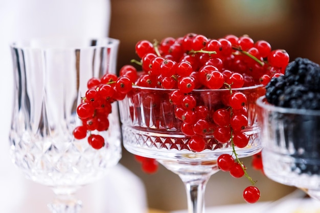 Glass filled with fresh berries of red currant Berries of the summer garden