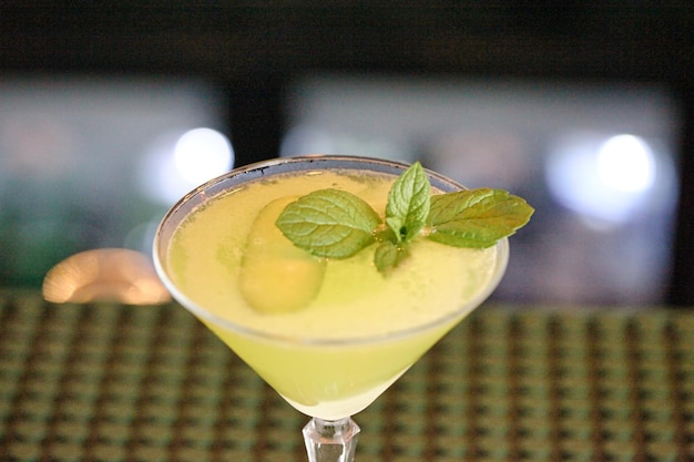 Glass Filled With Yellow Drink and Green Leaf