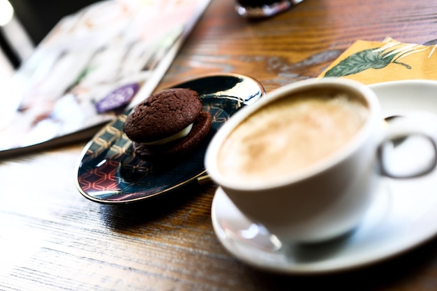 Glass of filter coffee with delicious cookies