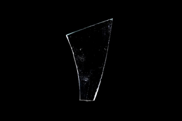 Photo glass fragments in isolation on a black background. damaged window. damaged object. high quality photo