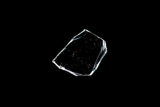 Glass fragments in isolation on a black background. damaged window. damaged object. High quality photo