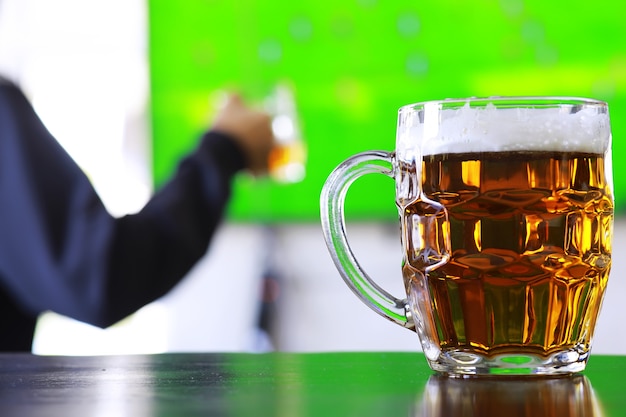 Glass of fresh beer on a wooden table. Lager beer mug on stone table. Top view with copy space