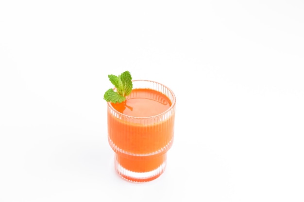 A glass of fresh carrot juice, very good for health. Served in glass on white background