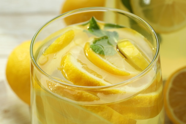 Glass of fresh lemonade with lemon slices, close up