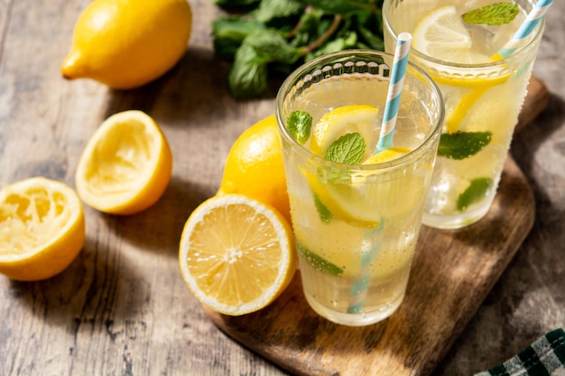 Glass of fresh lemonade on wooden table