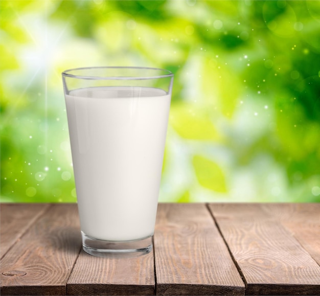 Glass of fresh milk on blurred background