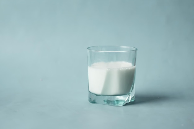 Glass of fresh milk on table