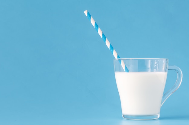 Glass of fresh milk with drinking straw