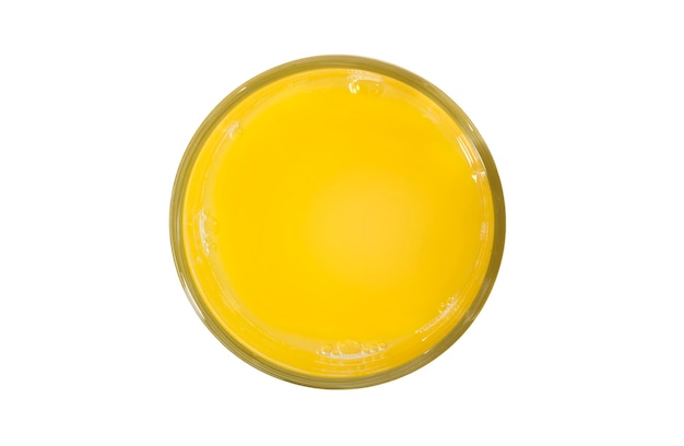 A glass of fresh orange juice on a white background top view