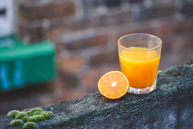 Glass of fresh orange juice on wooden table healthy drink for the body immune system