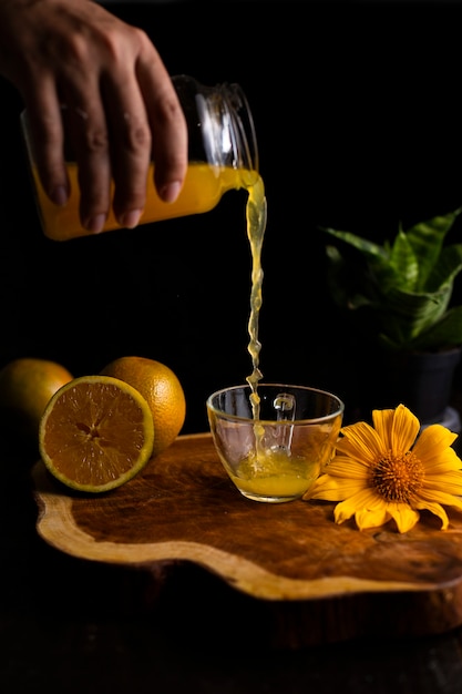 Glass of fresh orange juice on wooden table