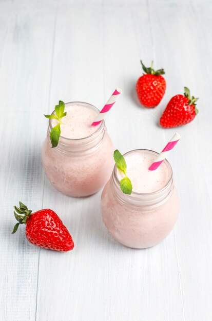 Glass of fresh strawberry milkshake, smoothie and fresh strawberries,healthy food and drink concept.