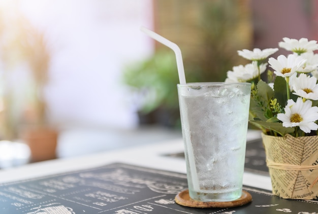 Glass of fresh water with ice on table