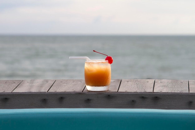 Glass of fruit punch with ocean view