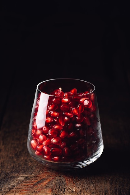 Glass full of red pomegranate seeds