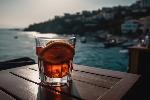 A glass glass with cold tea on a wooden table in an outdoor cafe on the seashore