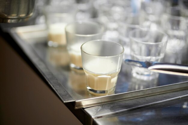 glass glasses with warm milk are on a metal tray on the kitchen table