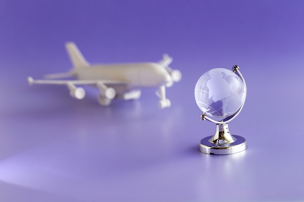 Glass globe and airplane model, travel and globalization concept