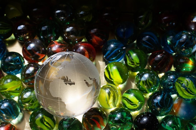 Glass globes of planet earth placed among marble balls Preservation of the environment