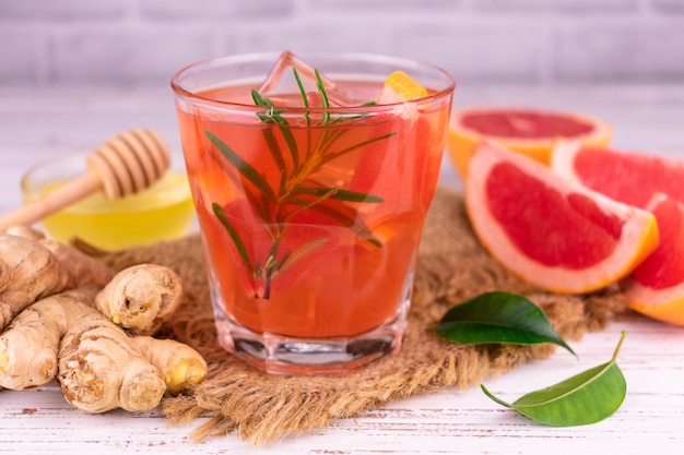 A glass of grapefruit juice with ginger